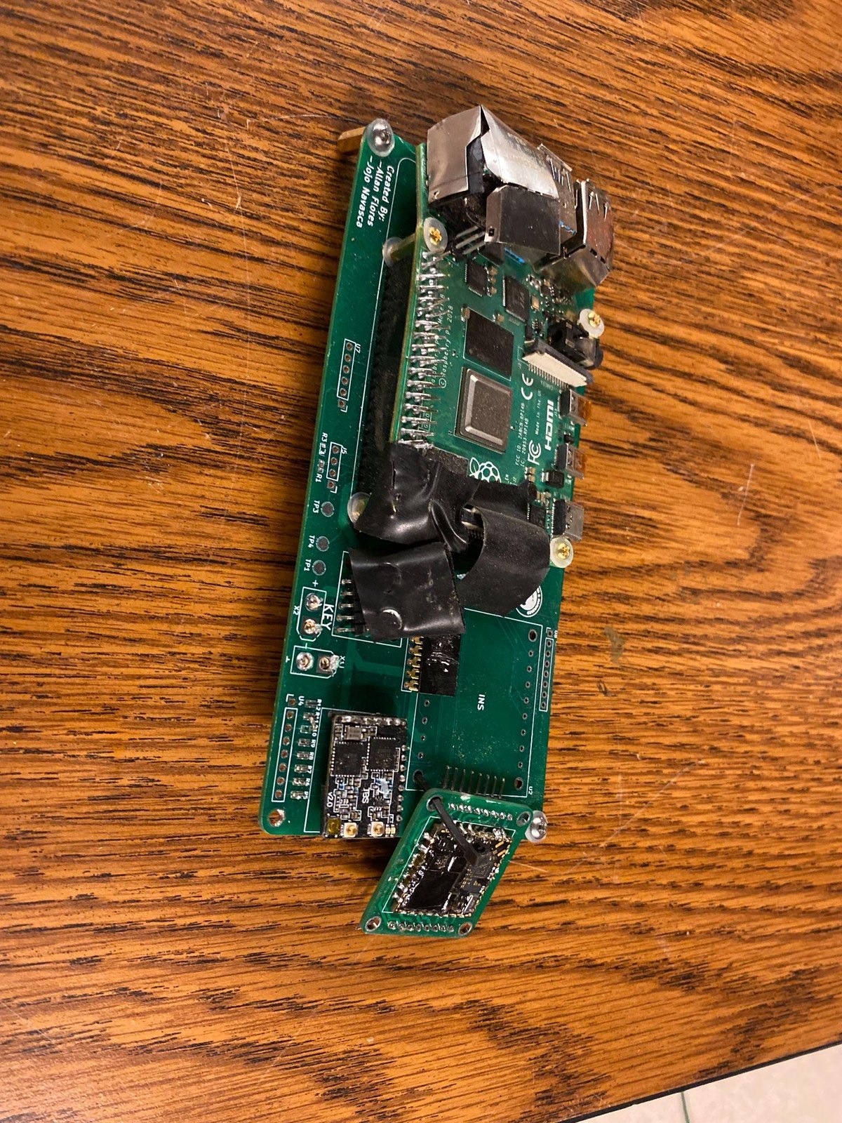 Close-up of payload avionics hardware and a Raspberry Pi mounted on a circuit board